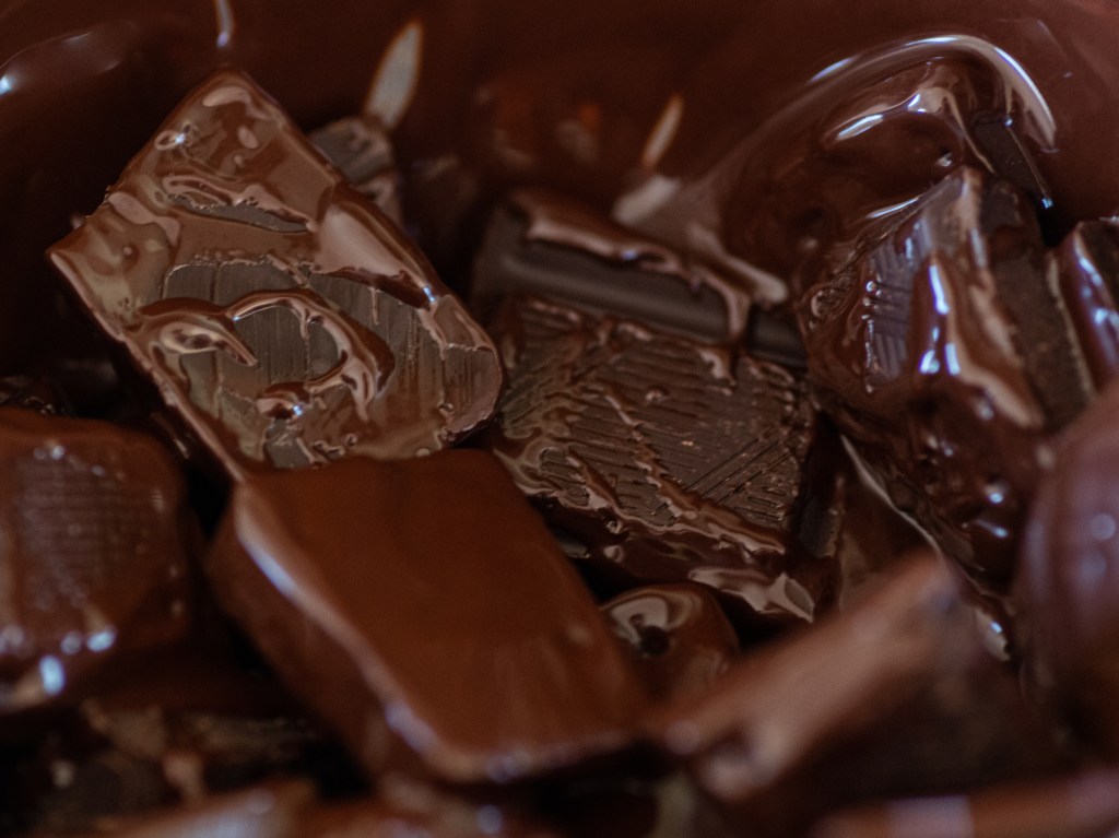 Melting chocolate; the squares are still visible but are definitely on the melting side.