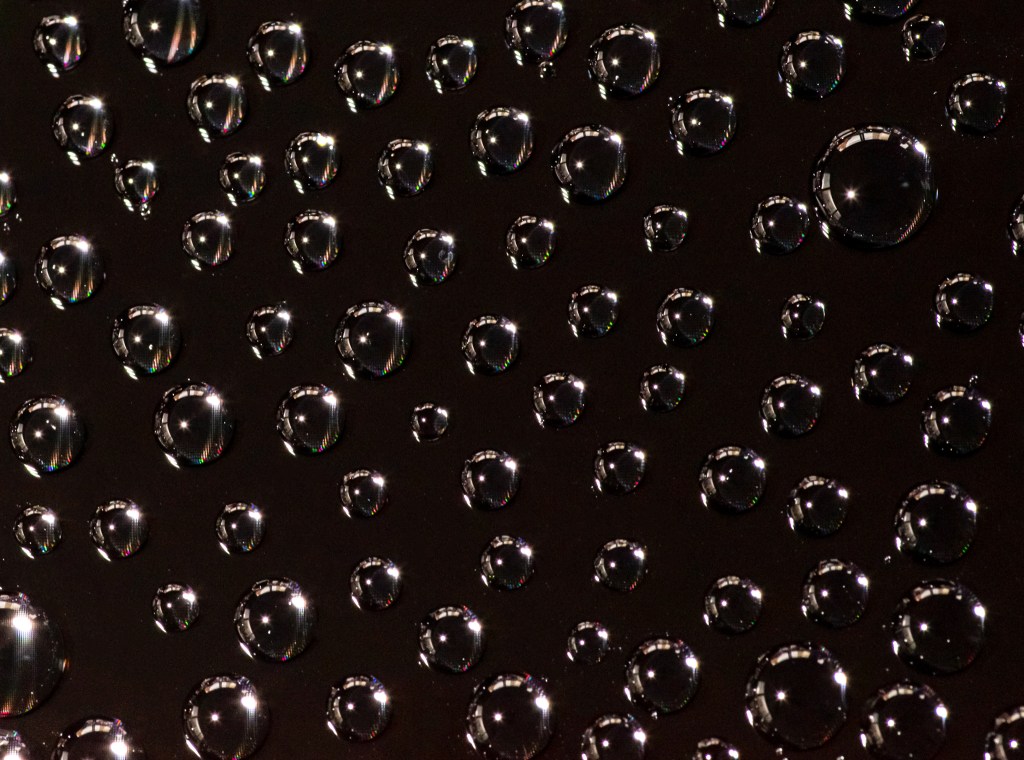 Droplets of water on a black surface