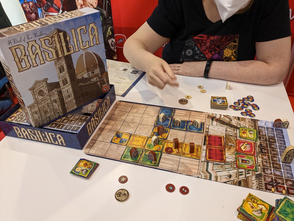 Basilica board - colored tiles in single-color areas, pawns and a scoring track.