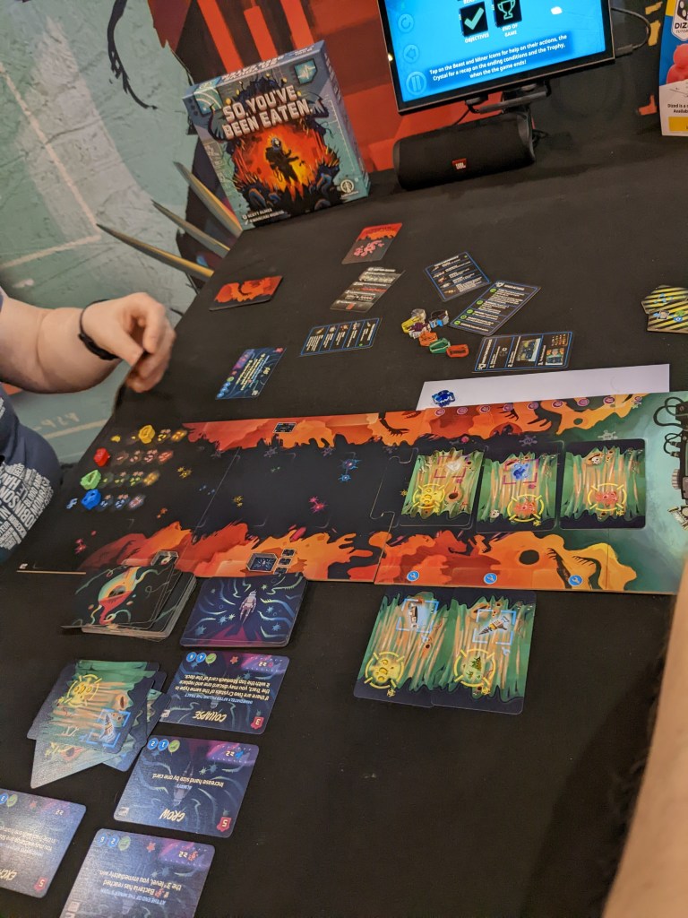 So You've Been Eaten - a track made of cards that show tools, crystals and bacteria, and some other action cards.