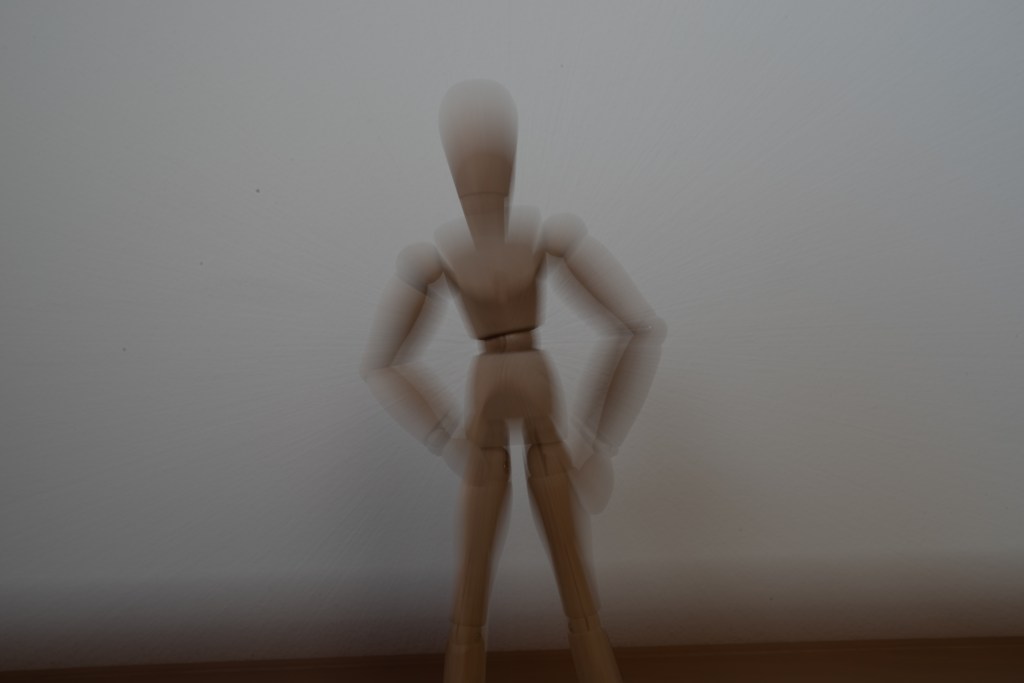 An unedited version of the previous image, where the manikin's movement is visible, but the manikin is clearly standing in front of a wall, which breaks the illusion.