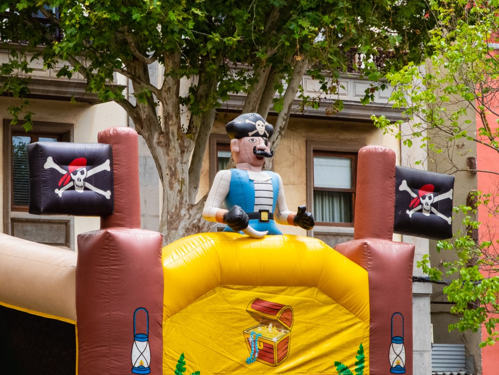 Top of an inflatable castle with a "pirate" theme - inflatable walls, inflatable pirate, inflatable pirate flags.
