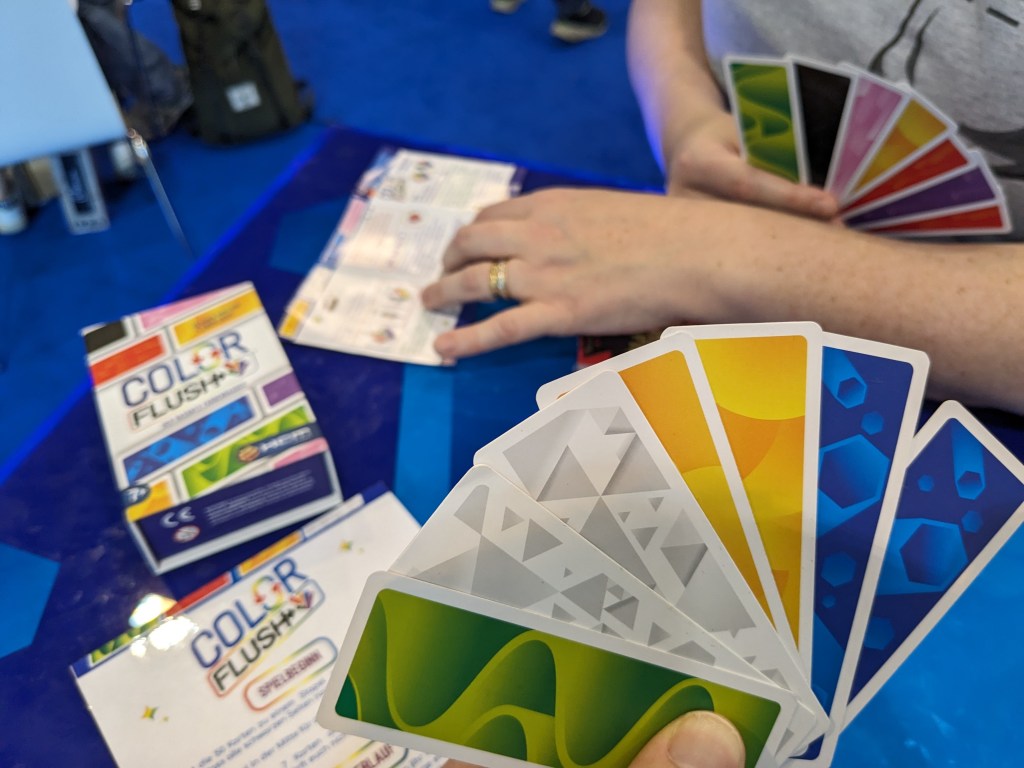 Color Flush: two players with a hand of cards that look like colorful bookmarks