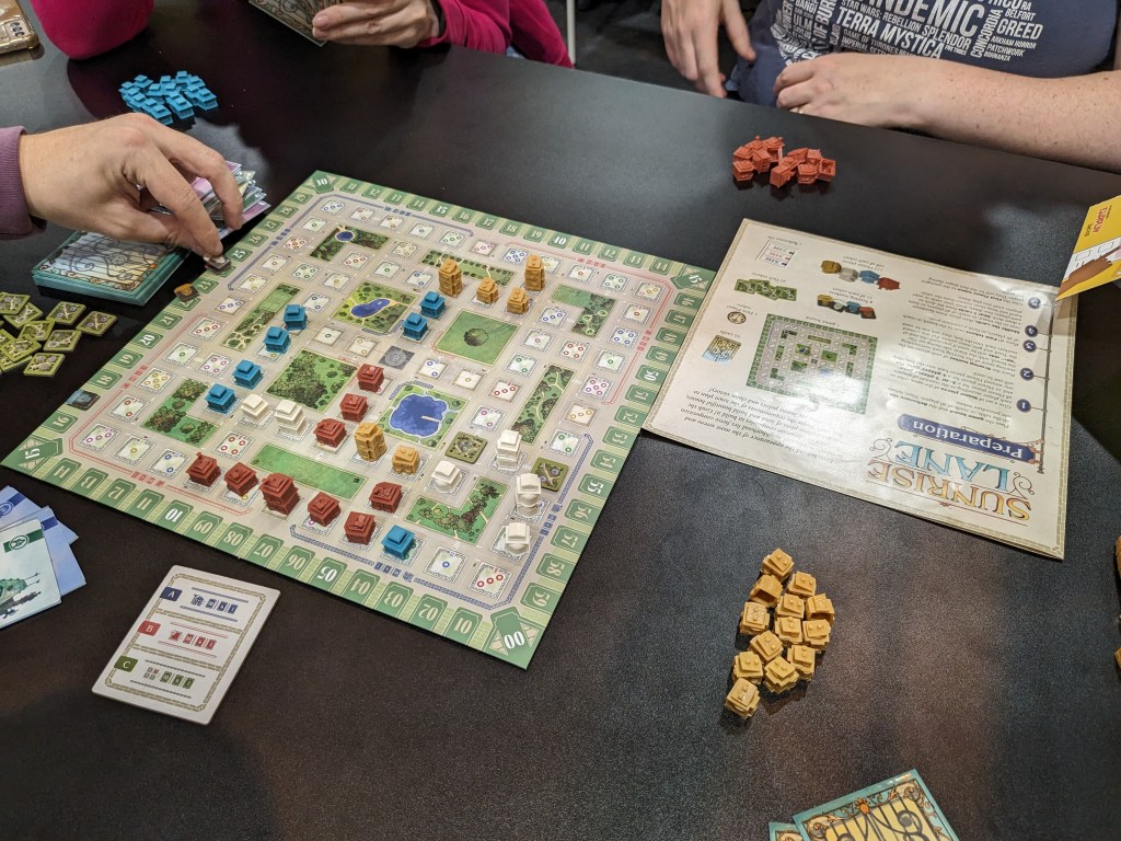 Sunrise Lane: a board with colored buildings of different heights on it.