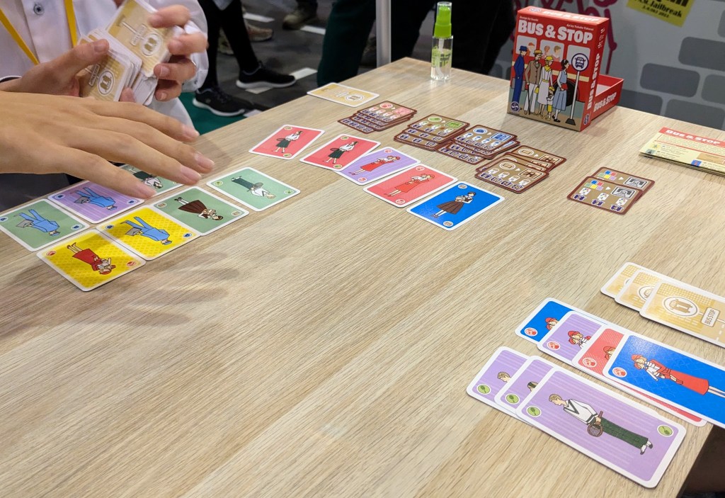 Bus&Stop: colored cards with tennis players, child minders, business people and students, as well as scoring cards in the background