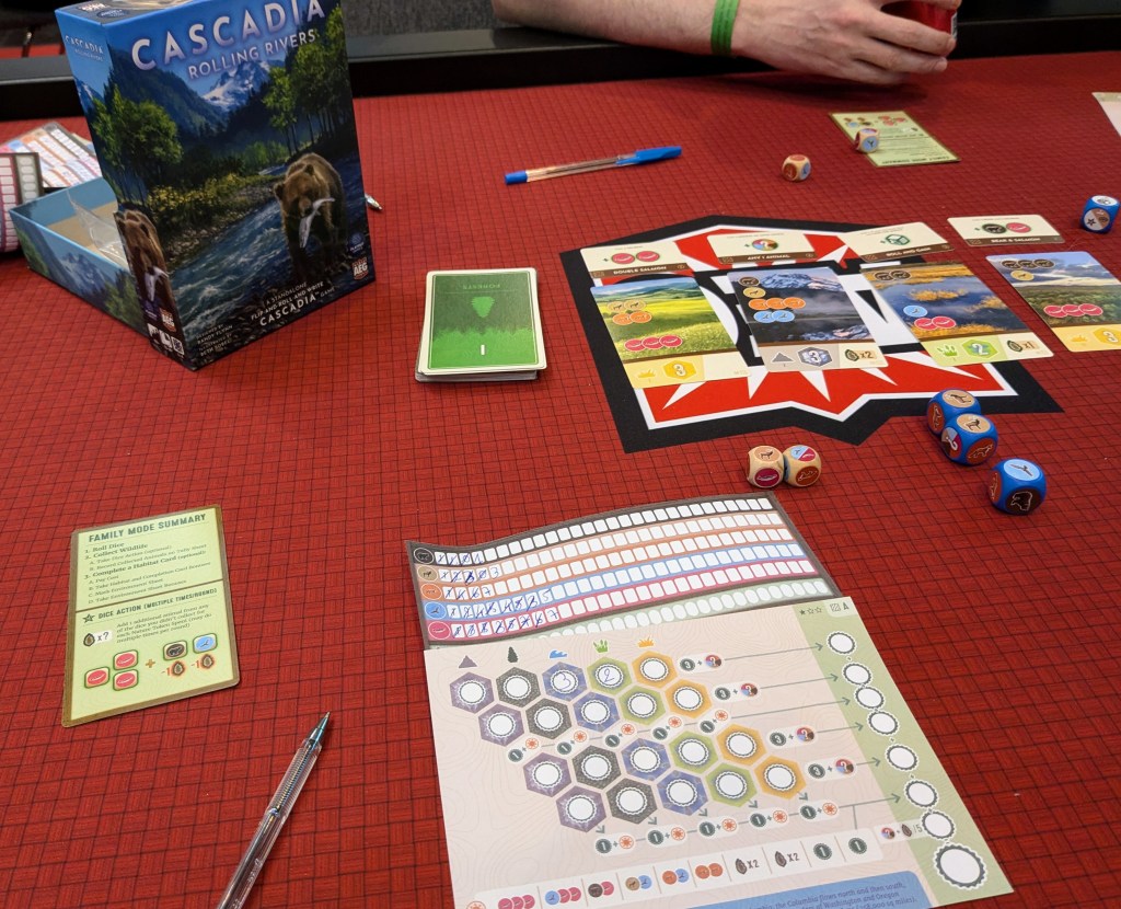 Cascadia Rolling Rivers: Scoring cards, dice and game sheets with numbers written on them