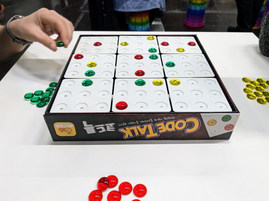 CodeTalk: a 9×9 grid separated into 9 squares, with colored pebbles on top