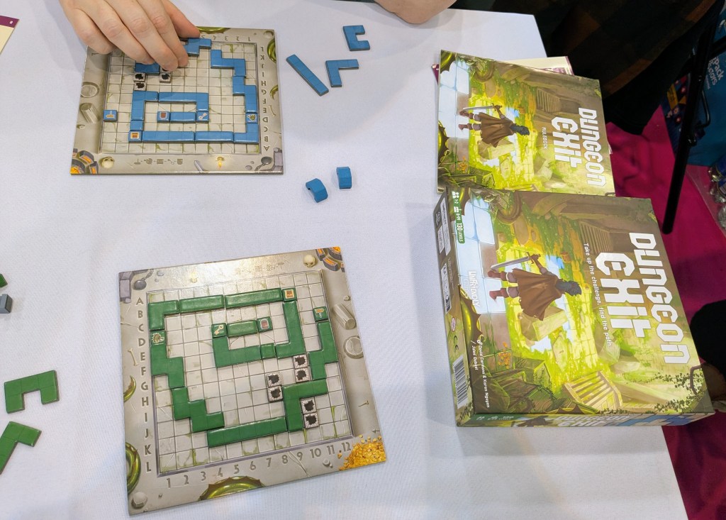 Dungeon Exit: square boards with polyomino pieces assembled in a path on them