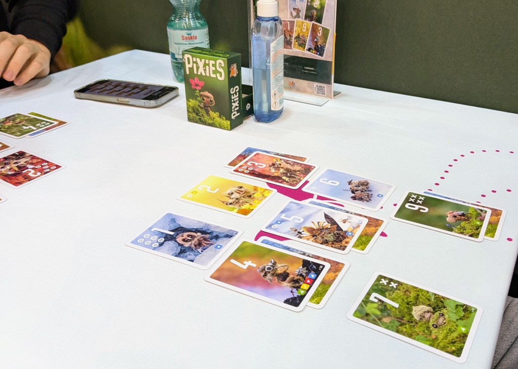 Pixies: a grid of cards from 1 to 9, in different colors. Some cards have another card tucked below them.