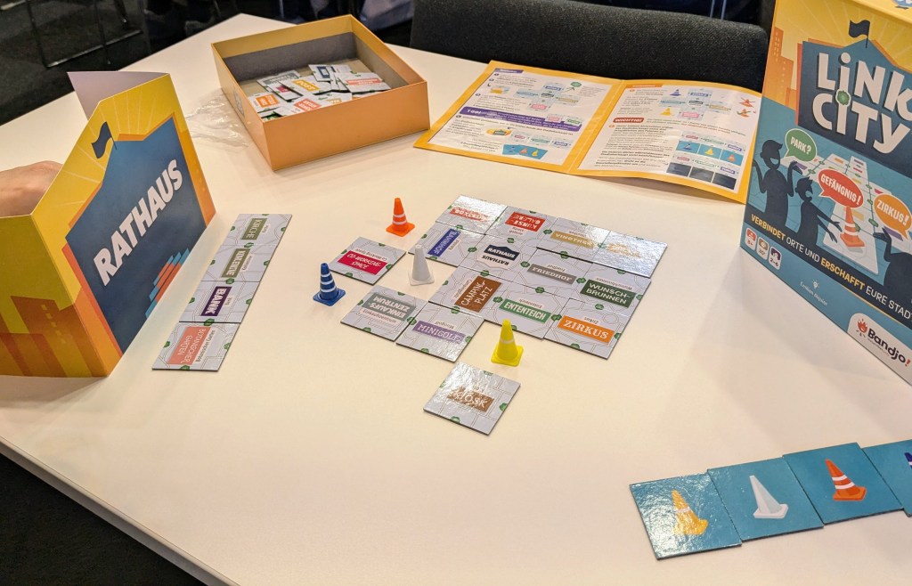 Link City: tiles with names of city places and small plastic traffic cones