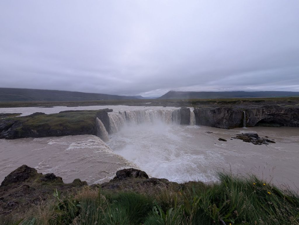 A wide and powerful waterfall between two rock walls