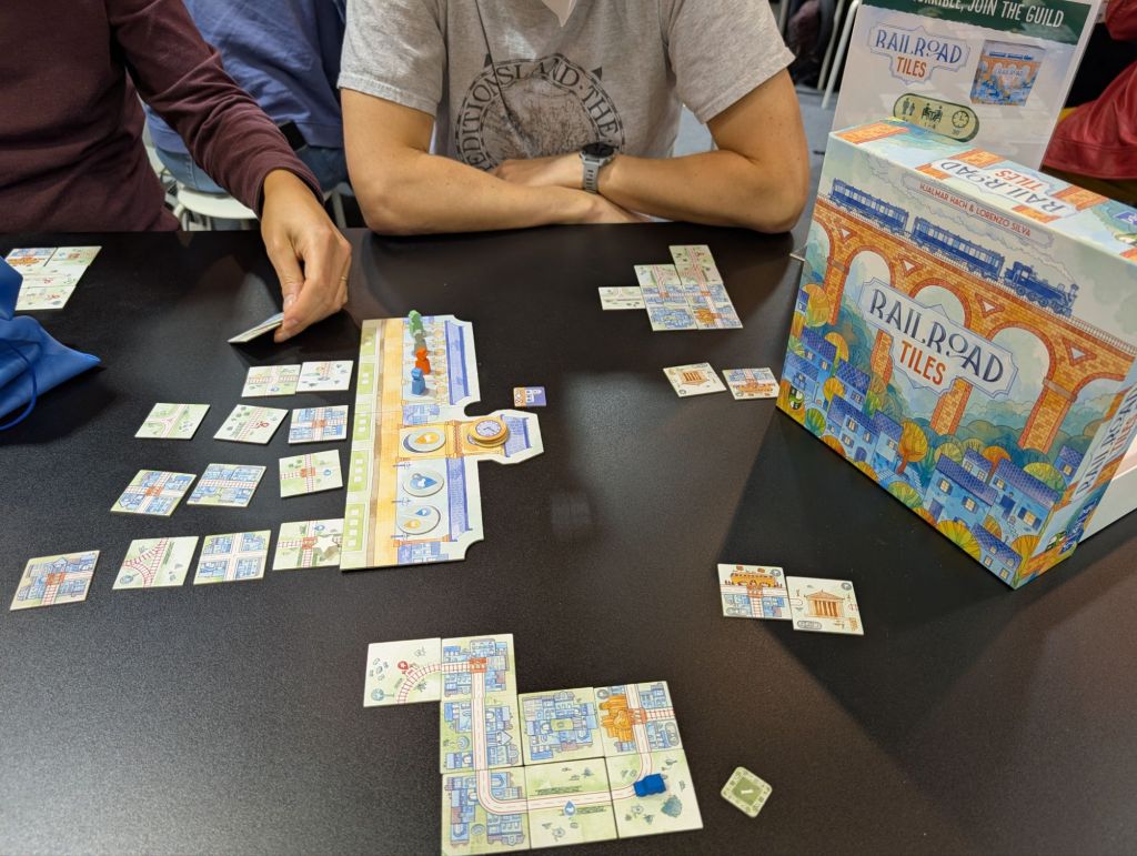 Tiles with railroads and streets, in a common market and placed in front of players as the start of a transport network.