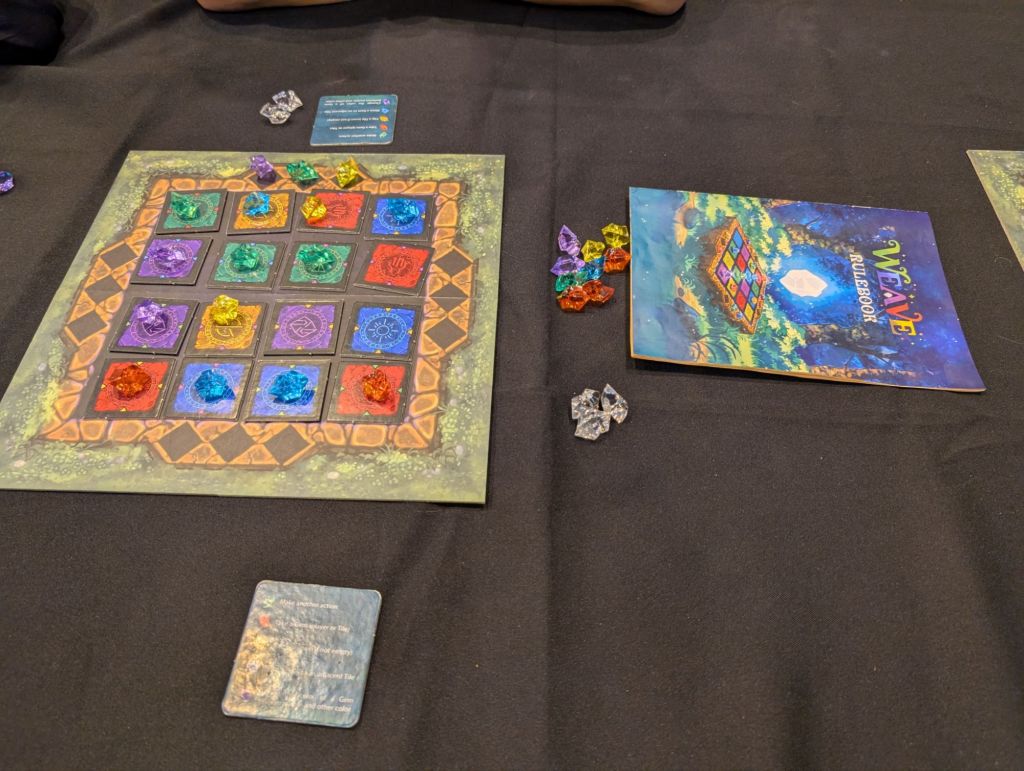 A 4x4 grid with squared colored tiles and a bunch of gems on the tiles. The colors of the gems are the same as the one from the tiles, but they do not necessarily match where they are.