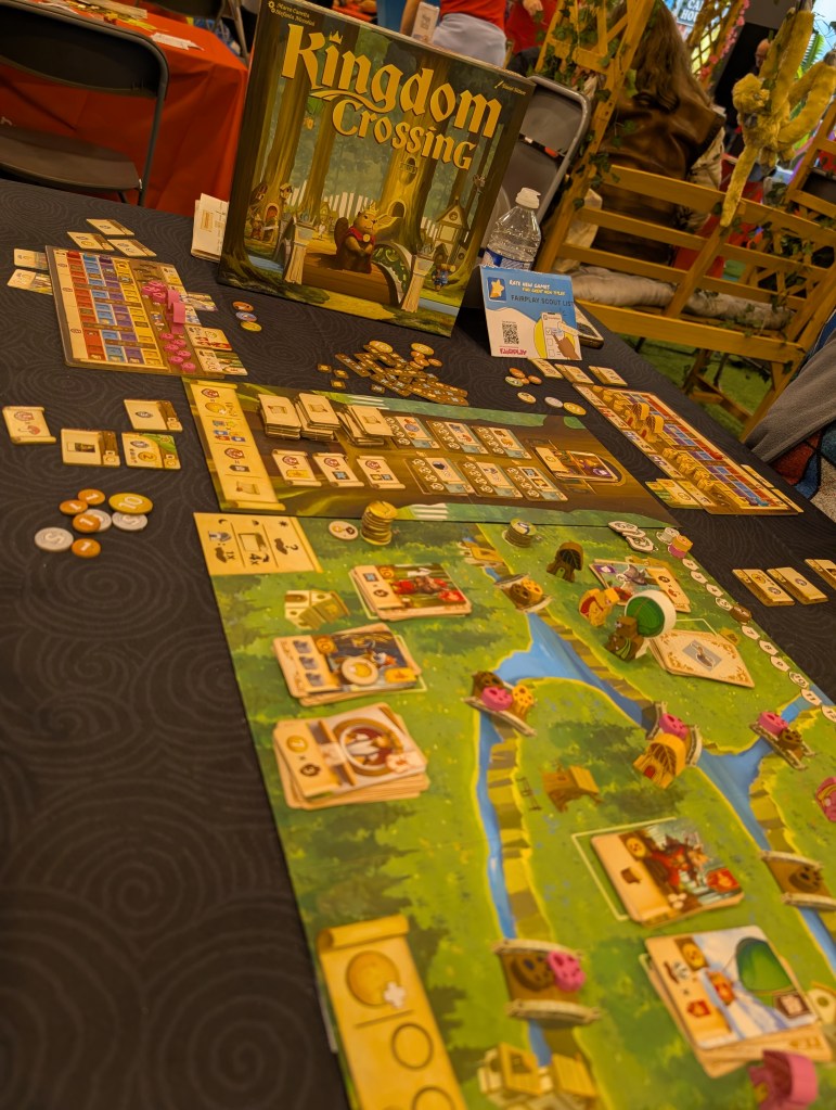 A board showing islands joined by bridges;  player boards show variousresources. The bridges have little paw tokens on them, and there's a bunch of cards on in piles on the board. The design is very cute.